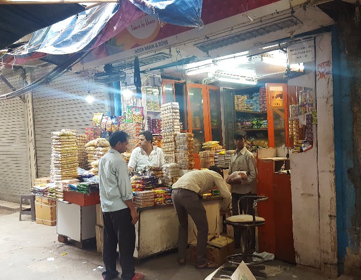 Market,Public space,Marketplace,Stall,Selling,Bazaar,Street food,Building,Hawker,Shopkeeper