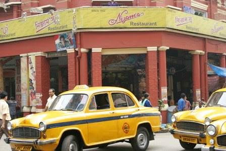 Land vehicle,Vehicle,Car,Classic car,Taxi,Sedan,Hindustan ambassador,Yellow,Compact car,Vintage car