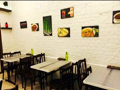 Restaurant,Wall,Room,Interior design,Table,Furniture,Building,Dining room,Brick,Fast food restaurant