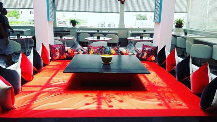 Restaurant,Red,Table,Room,Tablecloth,Interior design,Furniture,Textile,Meal,Flooring