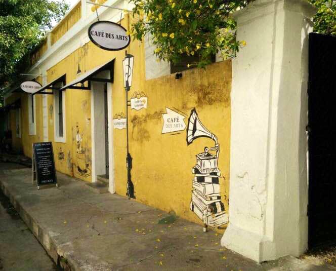 Wall,Yellow,Street art,Street,Neighbourhood,Art,Building,House,Road,Tree