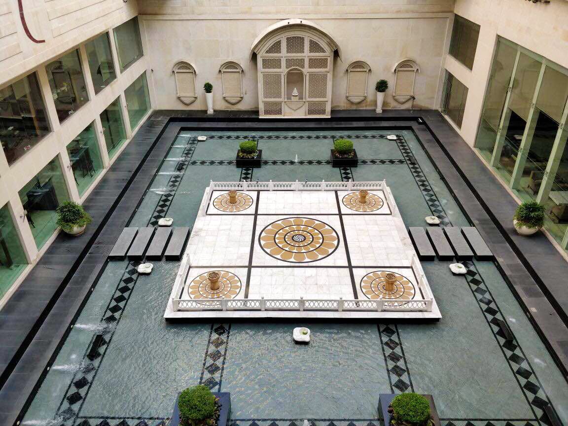 Courtyard,Architecture,Games,Symmetry,Building,Room,Daylighting,Interior design,Floor,Tile