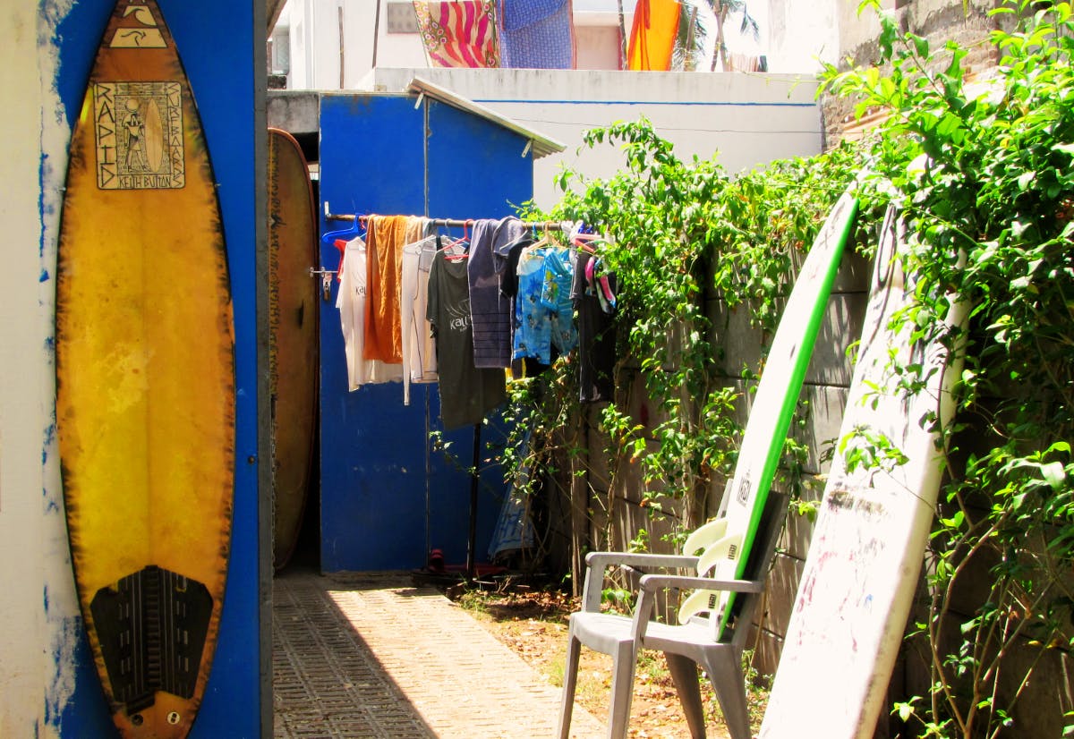 Surfboard,Surfing Equipment,Blue,Yellow,Majorelle blue,Neighbourhood,House,Tree,Street,Architecture
