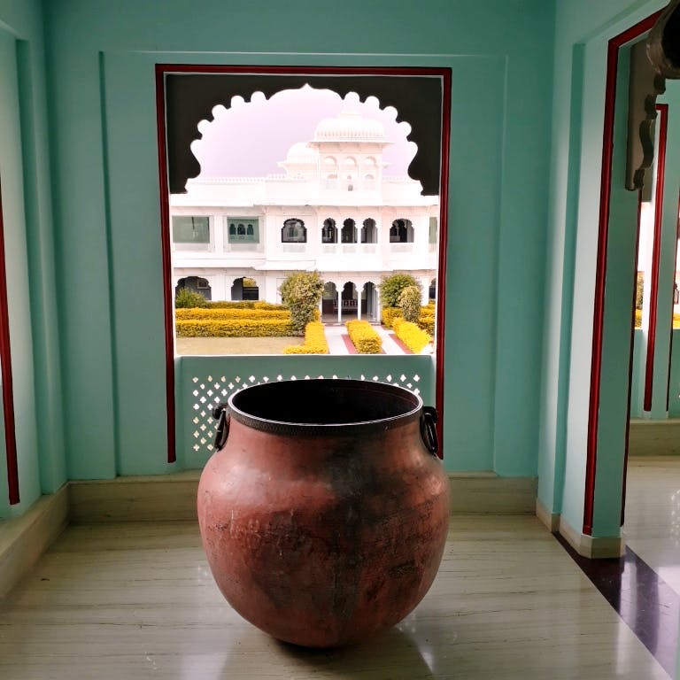 Room,Interior design,Urn,Pottery,Architecture,Table,Vase,Artifact,Furniture,House