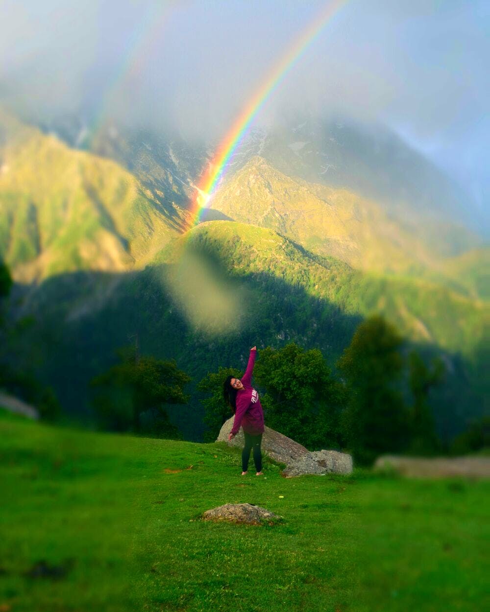 Rainbow,People in nature,Highland,Nature,Sky,Mountainous landforms,Green,Hill,Grassland,Mountain