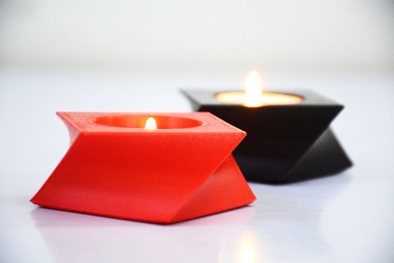 Candle,Lighting,Light,Wax,Orange,Material property,Table,Candle holder,Flame,Still life photography