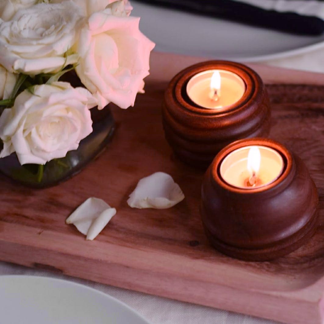 Candle,Lighting,Wax,Candle holder,Table,Petal,Flameless candle,Wood,Interior design,Flower
