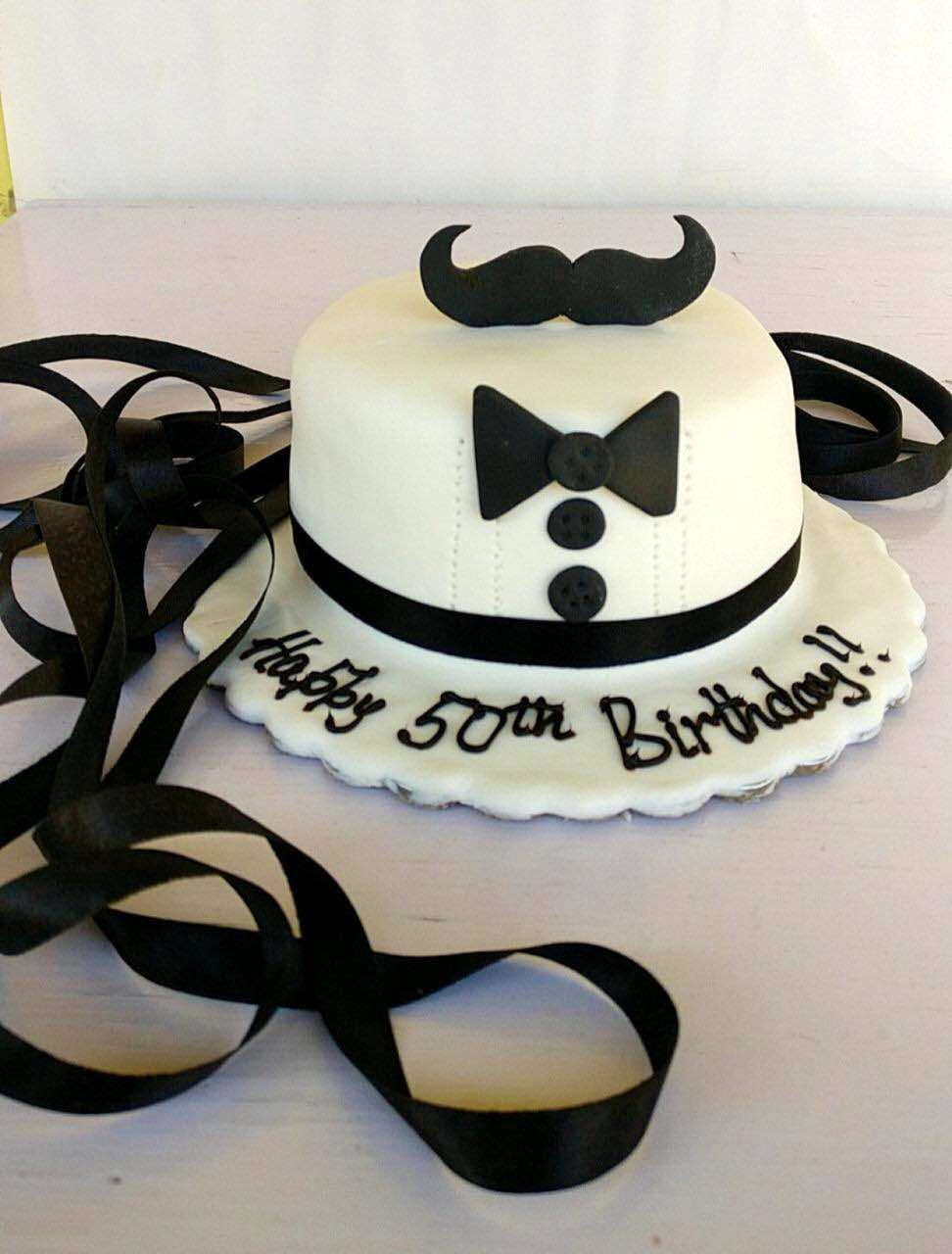 Black,Cake,Birthday cake,Fondant,Sugar cake,Sugar paste,Hat,Cake decorating,Costume accessory,Headgear