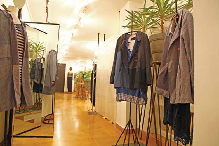 Boutique,Clothes hanger,Room,Outerwear,Textile,Building,Interior design,Floor,Furniture