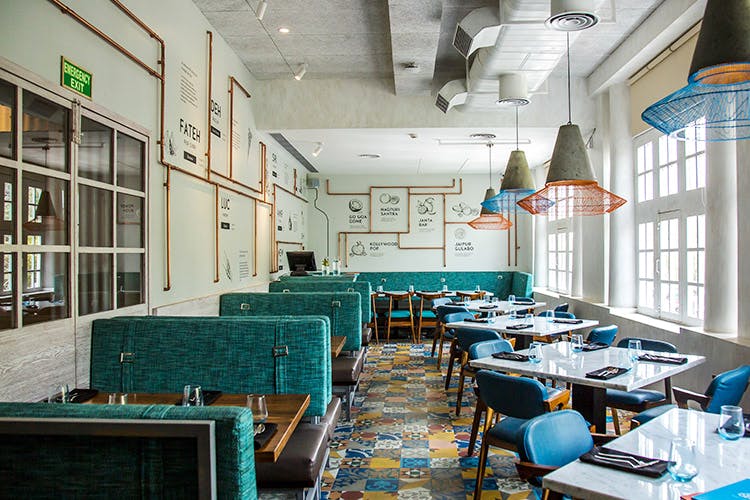 Building,Room,Turquoise,Interior design,Restaurant,Furniture,Architecture,Table,Chair,Cafeteria