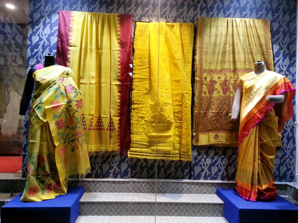 Yellow,Textile,Temple,Interior design,Stage,Curtain,Temple,Cope,Furniture,Place of worship