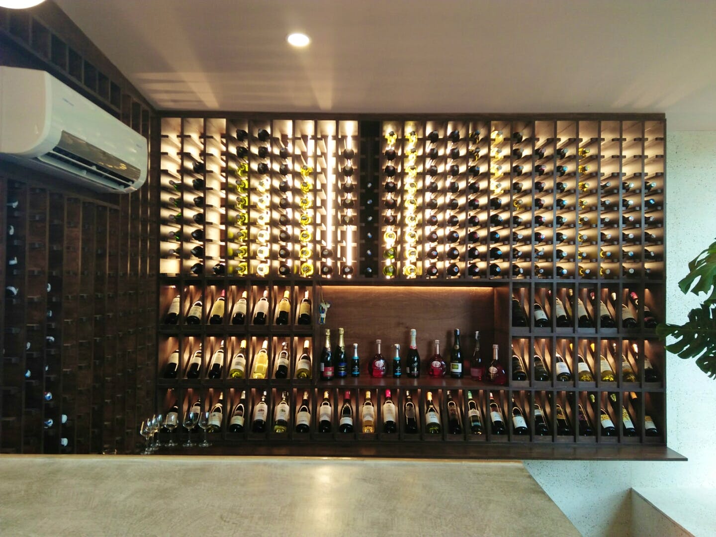 Wine cellar,Winery,Wine rack,Wine bottle,Wall,Architecture,Wine,Building,Interior design,Bottle