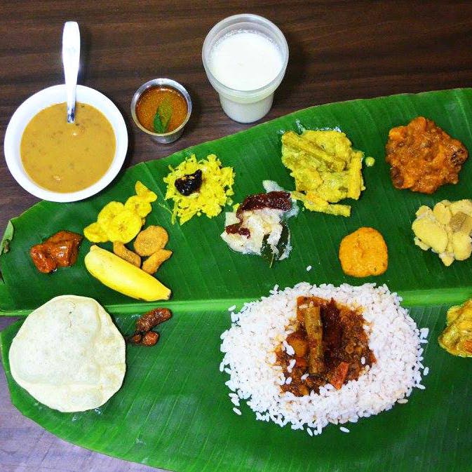 Dish,Food,Cuisine,Sadya,Banana leaf rice,Ingredient,Banana leaf,Meal,Rice,Andhra food