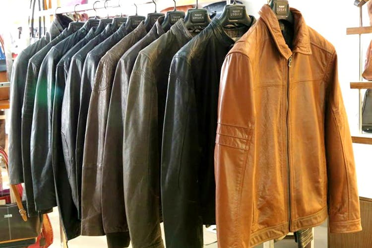 Clothing,Clothes hanger,Outerwear,Boutique,Jacket,Leather,Overcoat,Textile,Room,Leather jacket