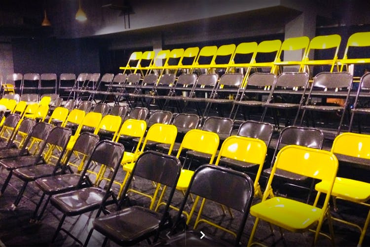 Auditorium,Yellow,Theatre,Sport venue,Stadium,Chair,Building,Room,Architecture,Audience