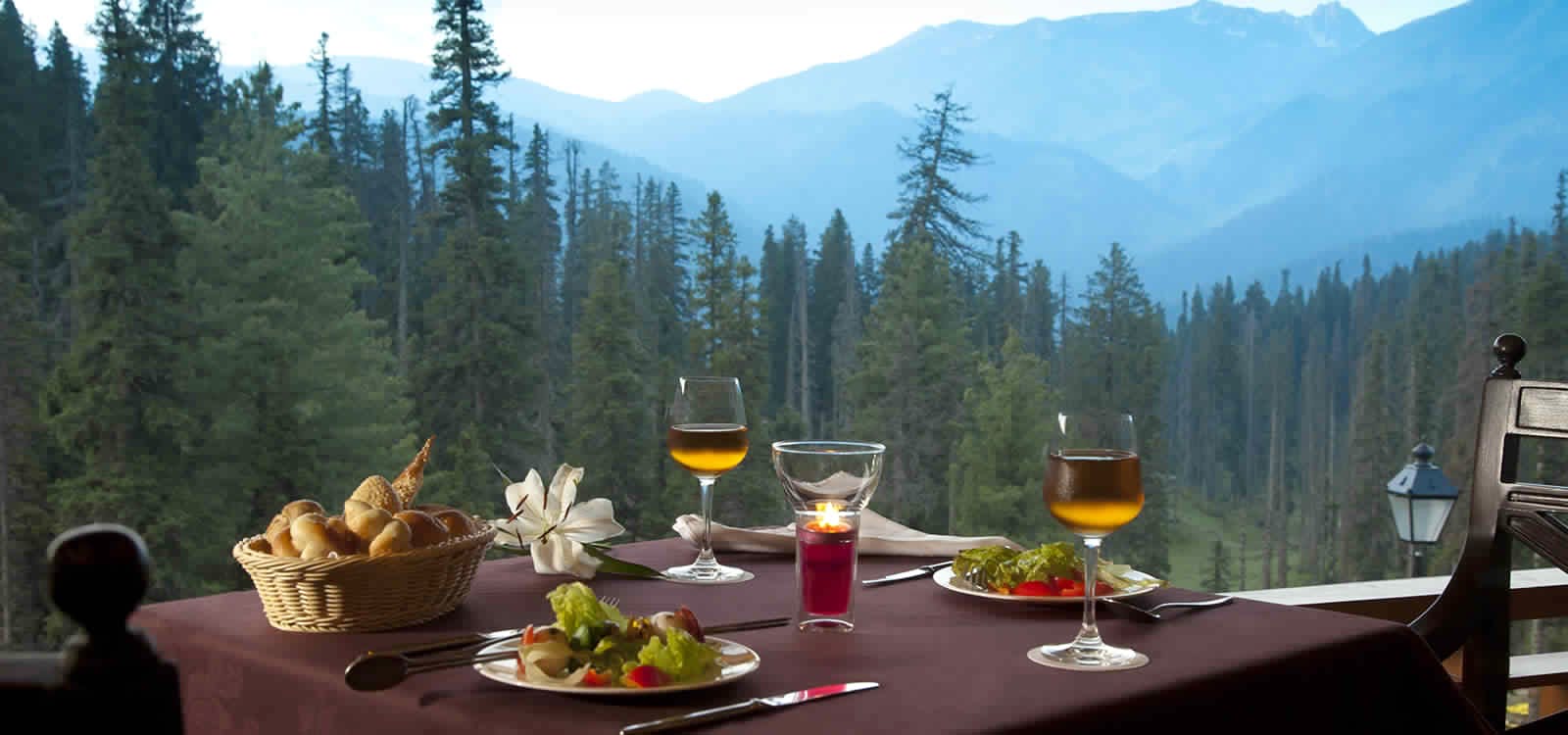 Mountain,Landscape,Meal,Tree,Mountain range,Drink,Vacation,Glass,Hill station,Breakfast