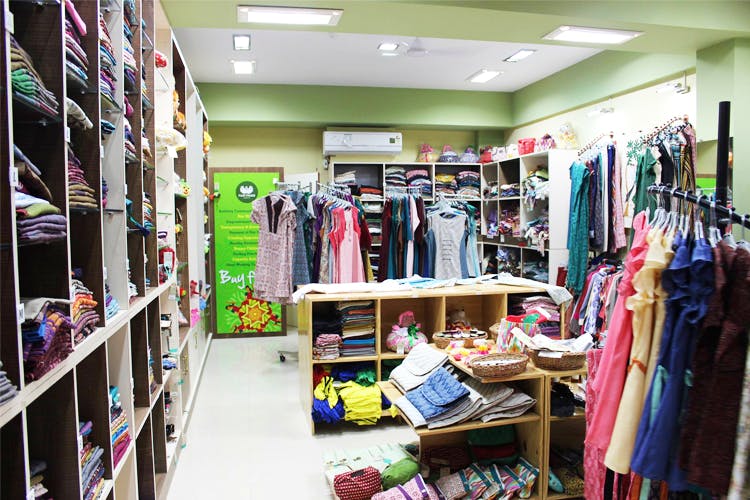 Outlet store,Room,Retail,Building,Boutique,Closet,Textile,Interior design,Floor,Furniture