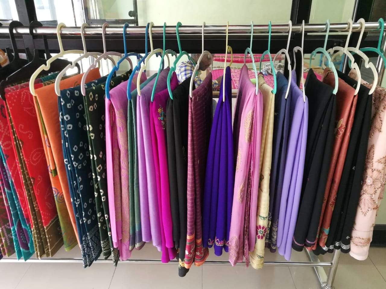 Clothes hanger,Clothing,Boutique,Pink,Room,Umbrella,Textile,Dress,Fashion accessory