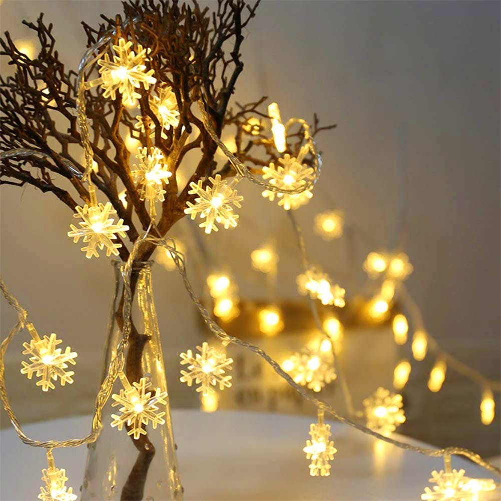 Branch,Lighting,Light fixture,Tree,Light,Yellow,Twig,Christmas lights,Christmas decoration,Interior design