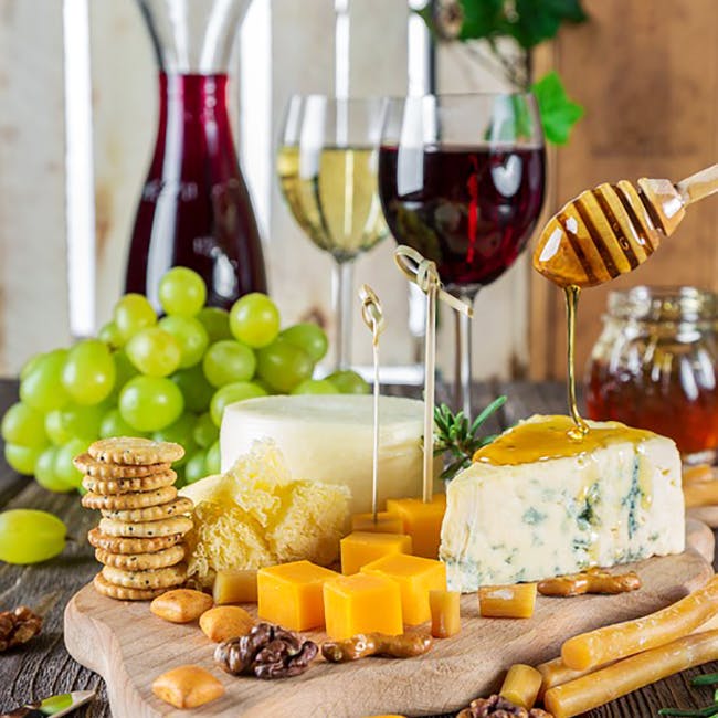 Food,Wine glass,Grape,Cheese,Stemware,Ingredient,Dairy,Cheddar cheese,Wine,Still life