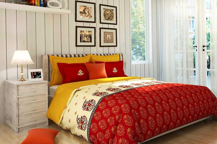 Bedroom,Bed sheet,Bed,Bedding,Furniture,Room,Orange,Red,Bed frame,Duvet cover