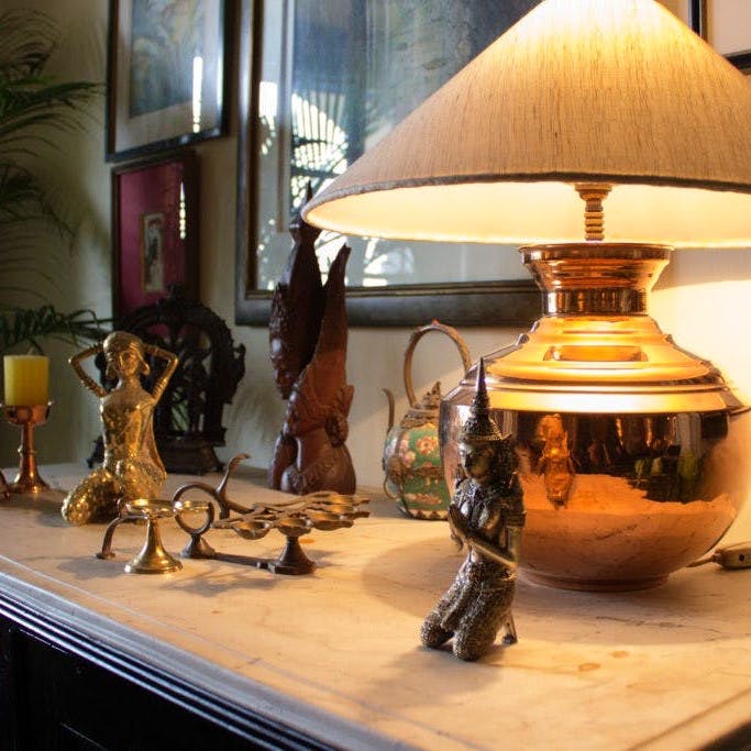 Lampshade,Lighting accessory,Lamp,Lighting,Table,Light fixture,Interior design,Furniture,Room,Antique