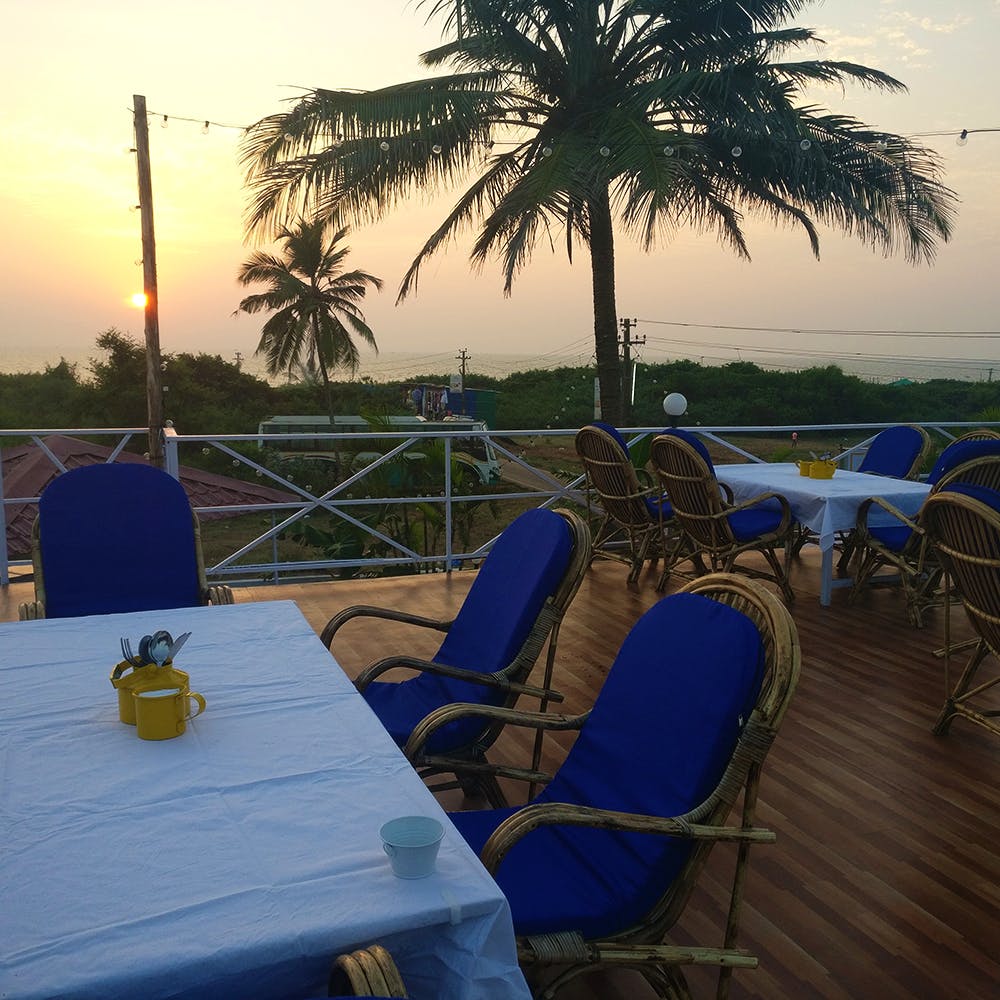 Restaurant,Sky,Vacation,Resort,Table,Tree,Palm tree,Arecales,Sunset,Evening