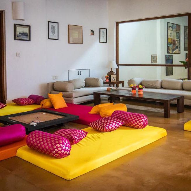 Room,Furniture,Living room,Interior design,Yellow,Property,Purple,Floor,Orange,Bed sheet