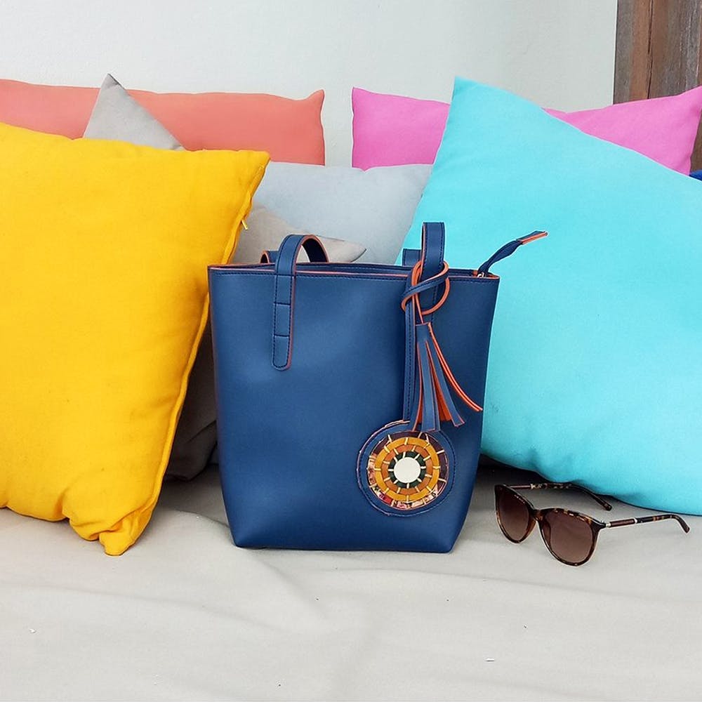 Cushion,Turquoise,Pillow,Throw pillow,Bag,Orange,Handbag,Furniture,Yellow,Aqua