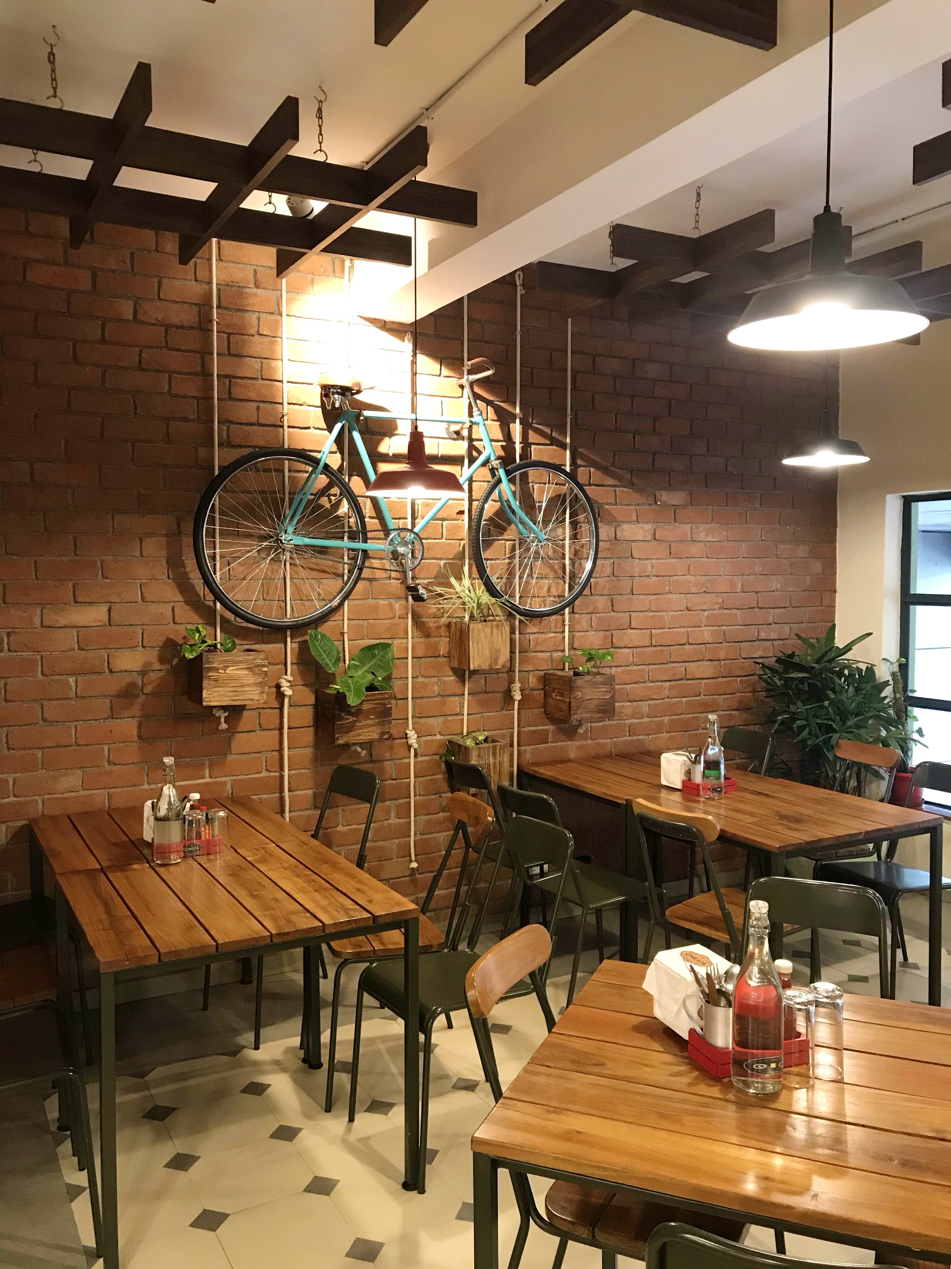 Room,Table,Building,Interior design,Ceiling,Furniture,Restaurant,Café,Bicycle,Bicycle wheel