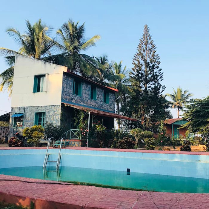 Swimming pool,Property,Resort,Palm tree,Vacation,House,Tree,Building,Turquoise,Real estate