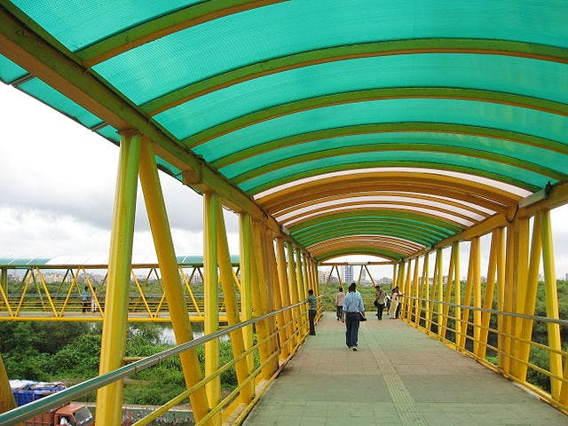 Bridge,Yellow,Skyway,Overpass,Pedestrian,Infrastructure,Walkway,Architecture,Shade,Nonbuilding structure