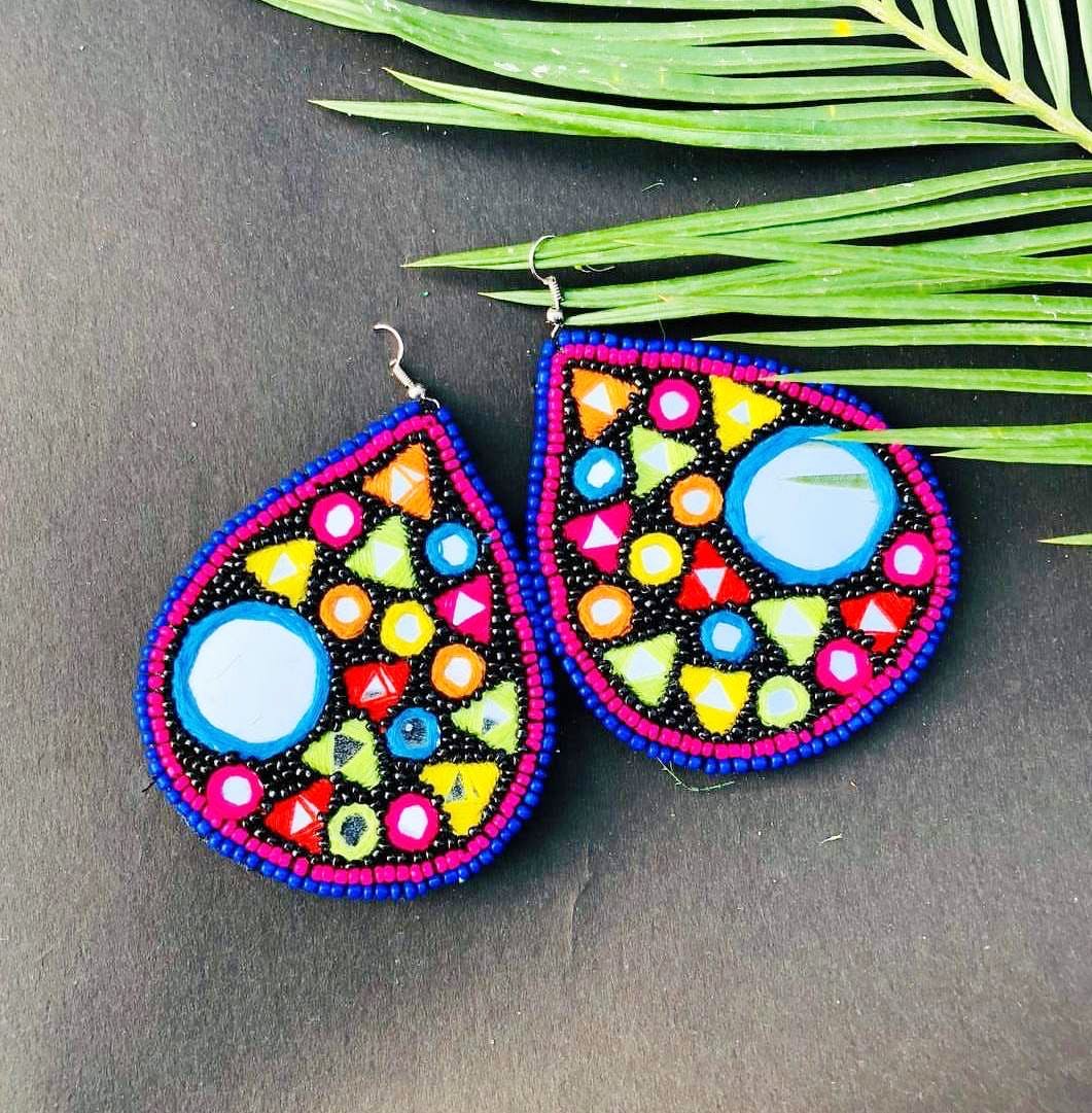 Earrings,Fashion accessory,Jewellery,Ornament,Bead,Pendant,Visual arts,Circle