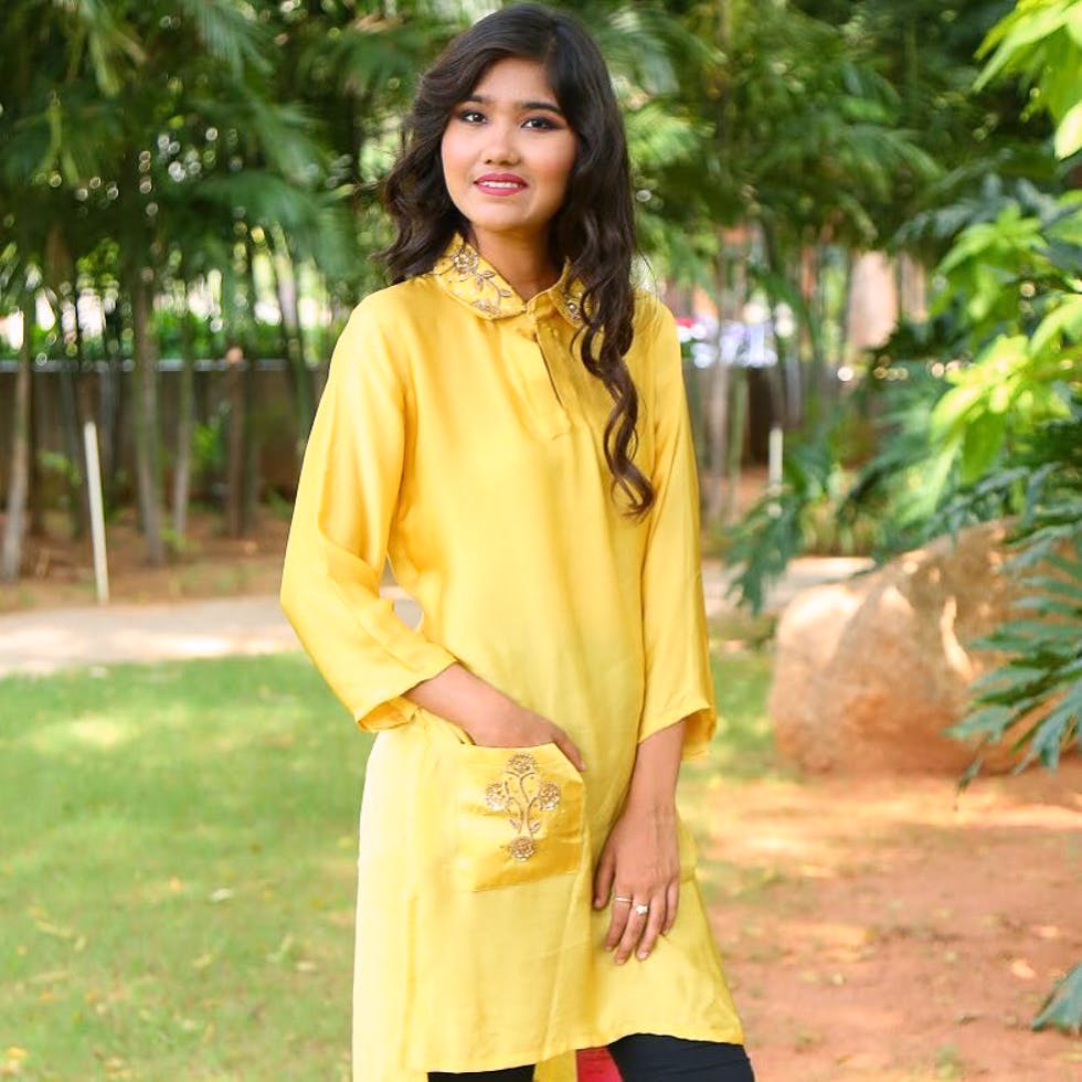 Clothing,Yellow,Formal wear,Sleeve,Outerwear,Neck,Fashion model,Blouse,Textile,Street fashion