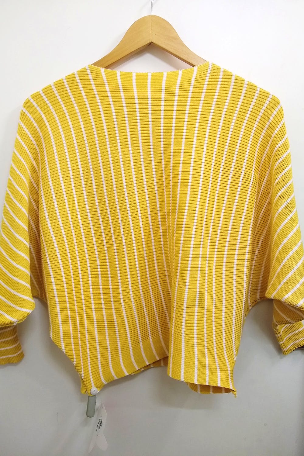 Clothing,Yellow,Outerwear,Sleeve,Sweater,Clothes hanger,Cardigan,Top,Beige,Collar