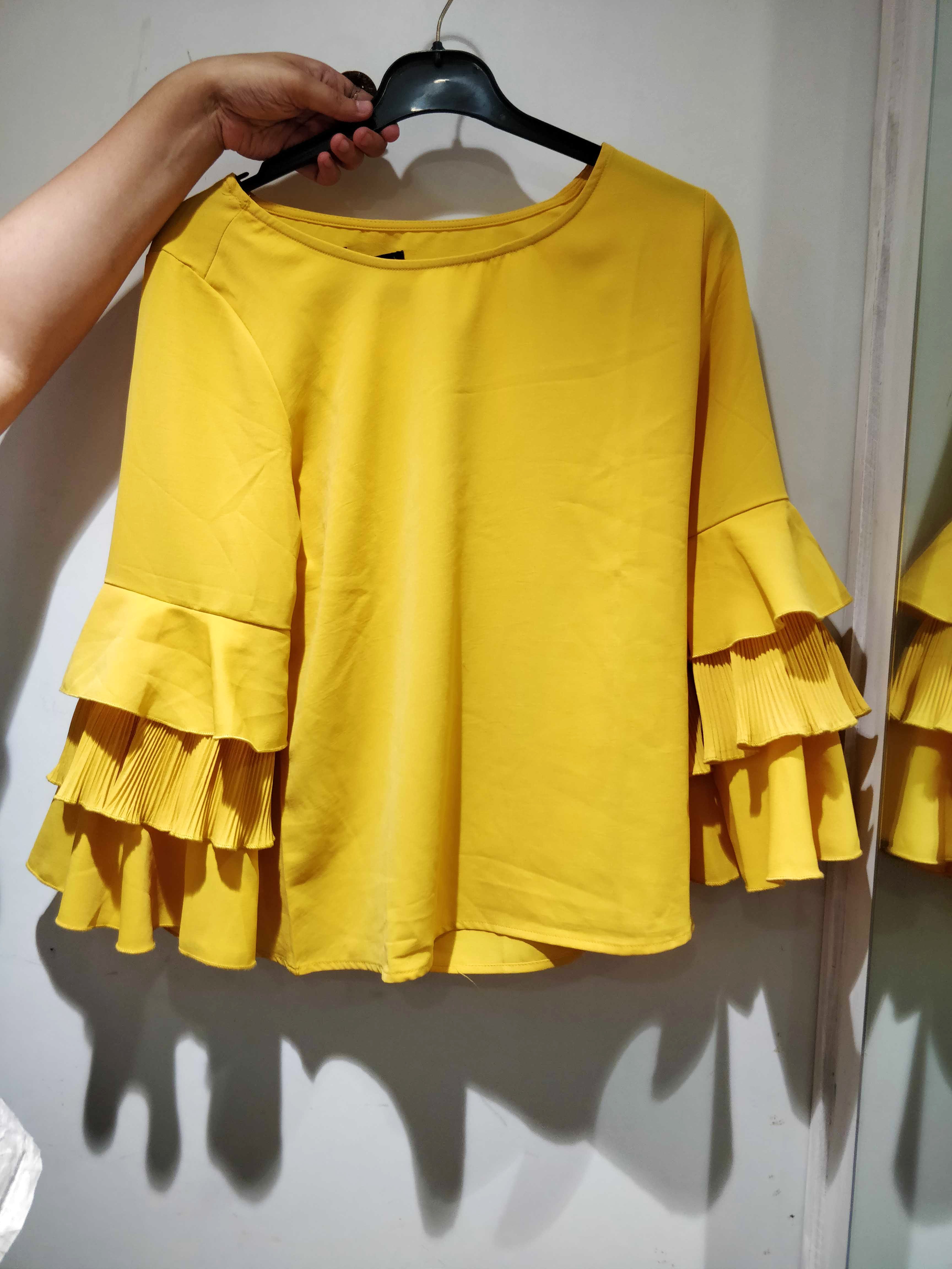 Clothing,Yellow,Clothes hanger,Outerwear,Sleeve,Blouse,Textile,Pattern,T-shirt,Top