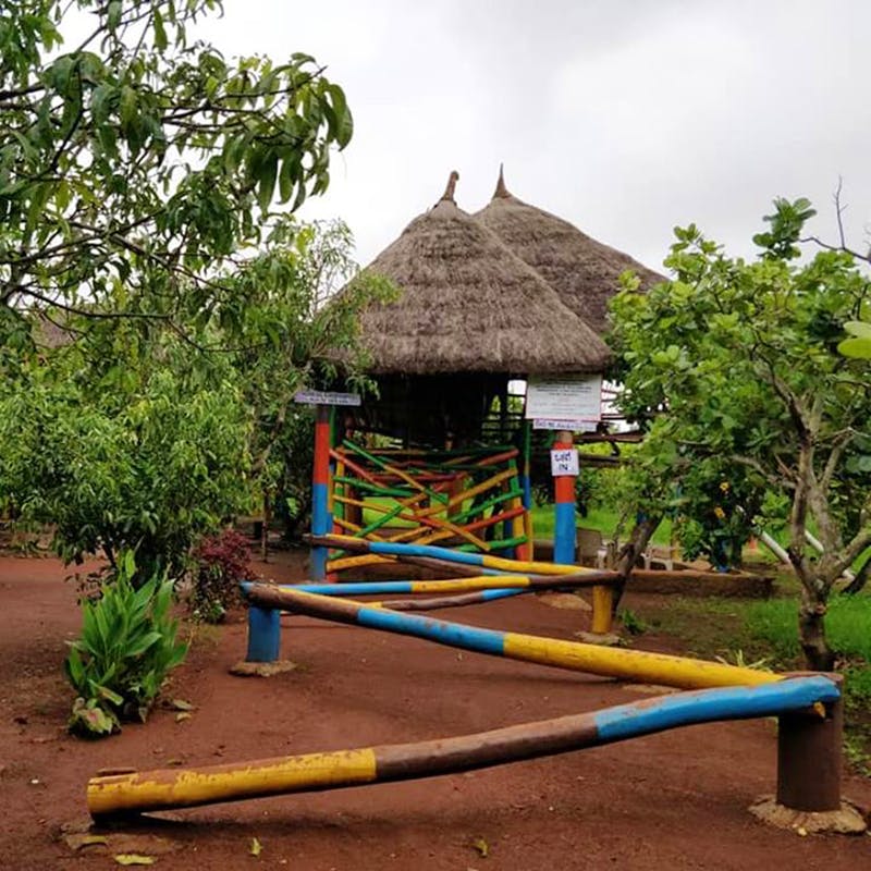 Public space,Roof,Hut,Tree,Thatching,Village,Playground,Landscape,House,Plant