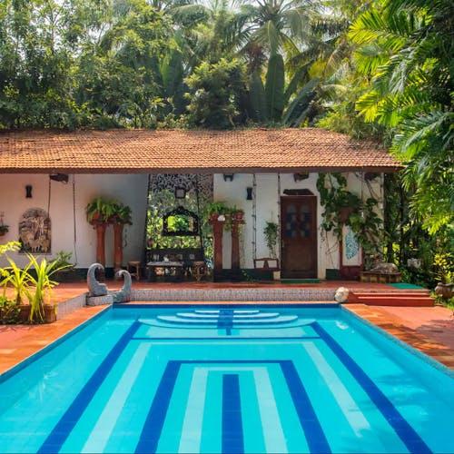 Swimming pool,Property,House,Building,Home,Real estate,Majorelle blue,Leisure,Vacation,Tree