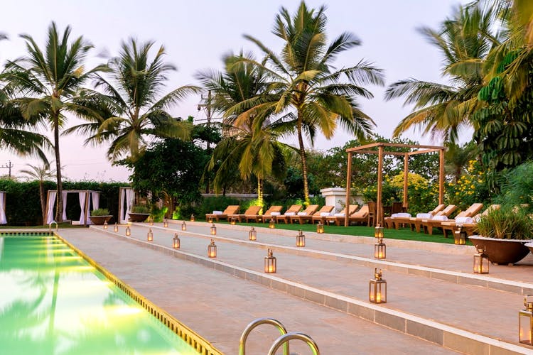 Resort,Swimming pool,Palm tree,Vacation,Property,Tree,Leisure,Arecales,Tropics,Hotel