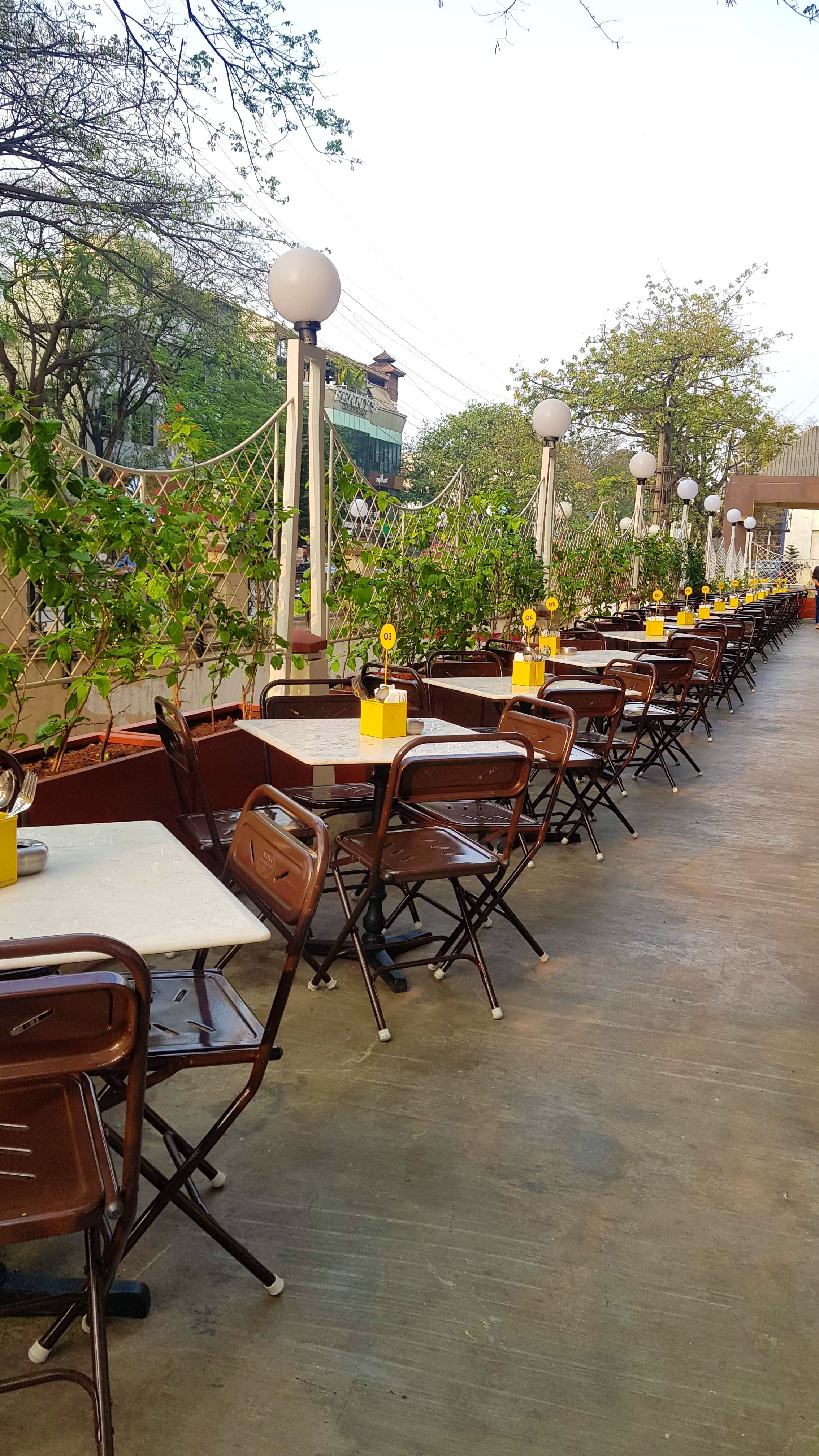 Property,Furniture,Table,Yellow,Restaurant,Chair,Real estate,Tree,Building,Architecture