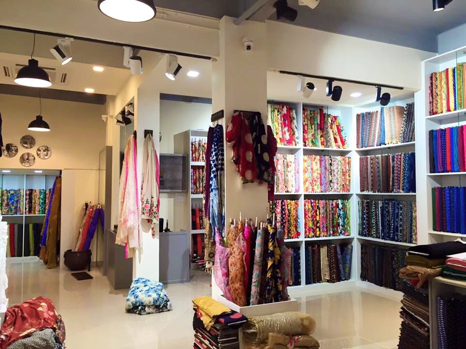 Boutique,Building,Room,Interior design,Ceiling,Outlet store,Retail,Textile,Floor,Furniture