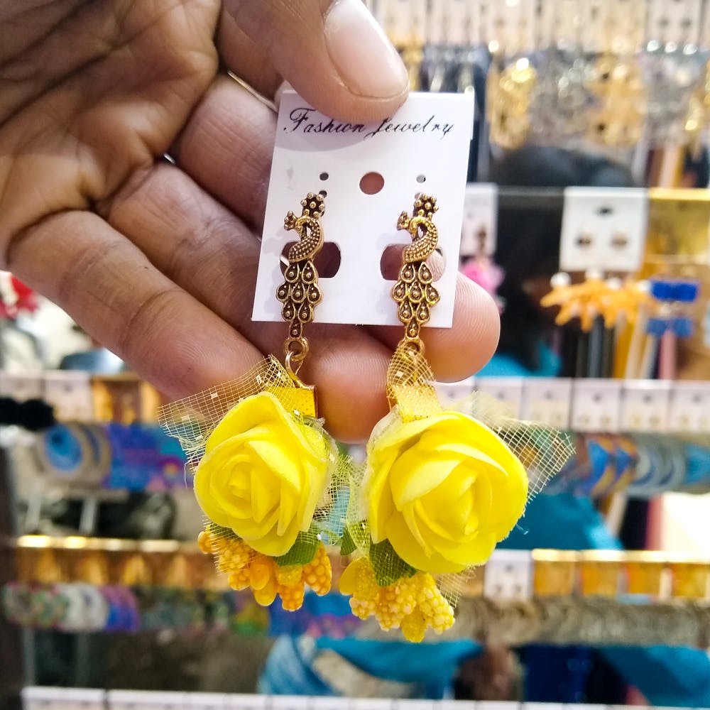 Yellow,Product,Fashion accessory,Jewellery,Fashion,Hand,Finger,Metal,Plant,Earrings