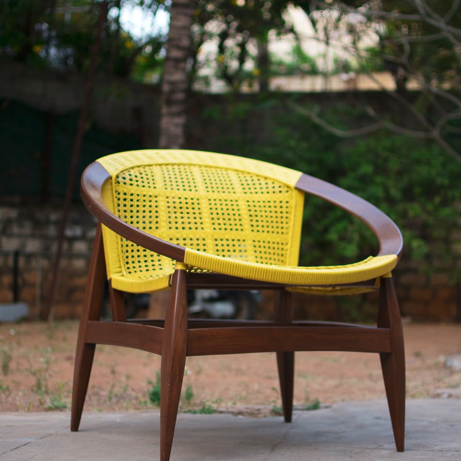 Chair,Furniture,Wicker,Outdoor furniture,Yellow,Table,Plant,Outdoor table