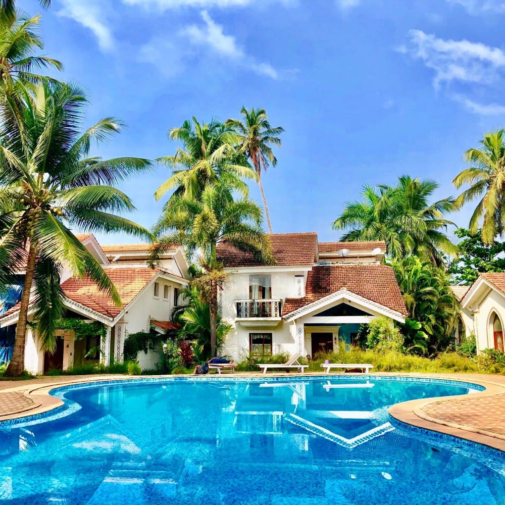 Swimming pool,Resort,Property,House,Vacation,Real estate,Building,Home,Sky,Palm tree