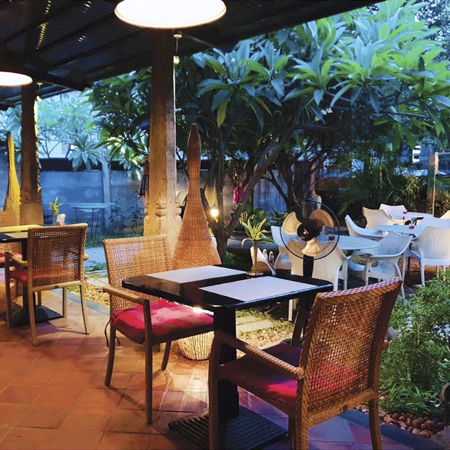 Restaurant,Outdoor table,Property,Lighting,Table,Furniture,Interior design,Patio,Room,Tree