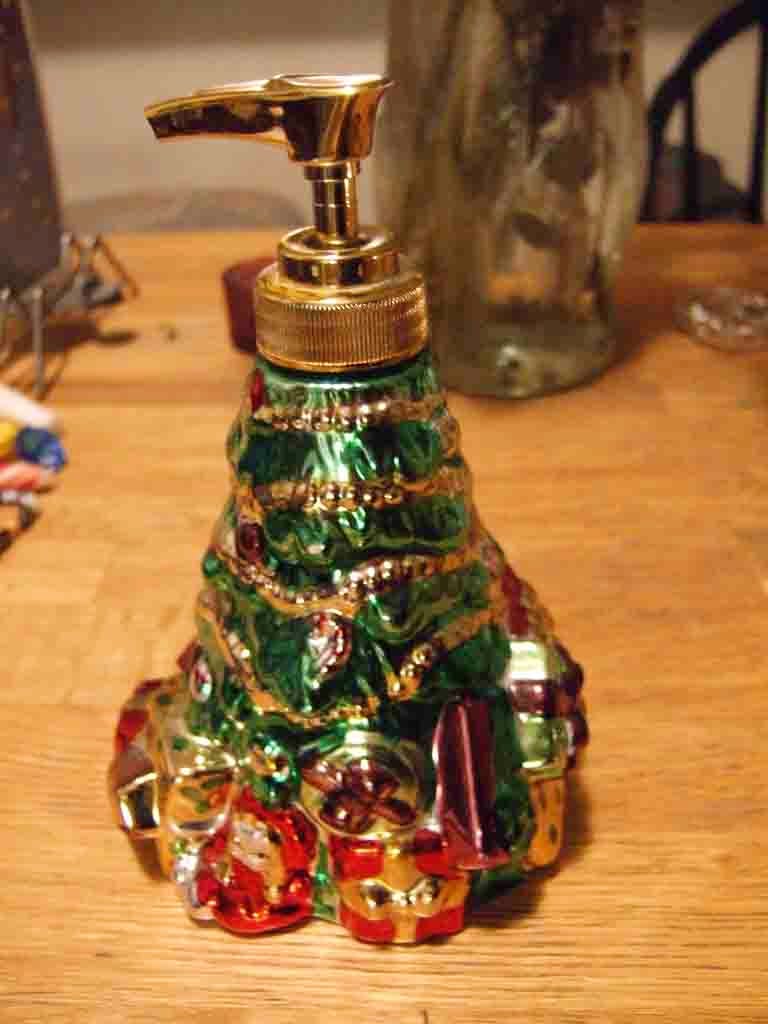Christmas tree,Christmas decoration,Tree,Brass,Christmas ornament,Interior design,Glass,Ornament,Soap dispenser,Metal