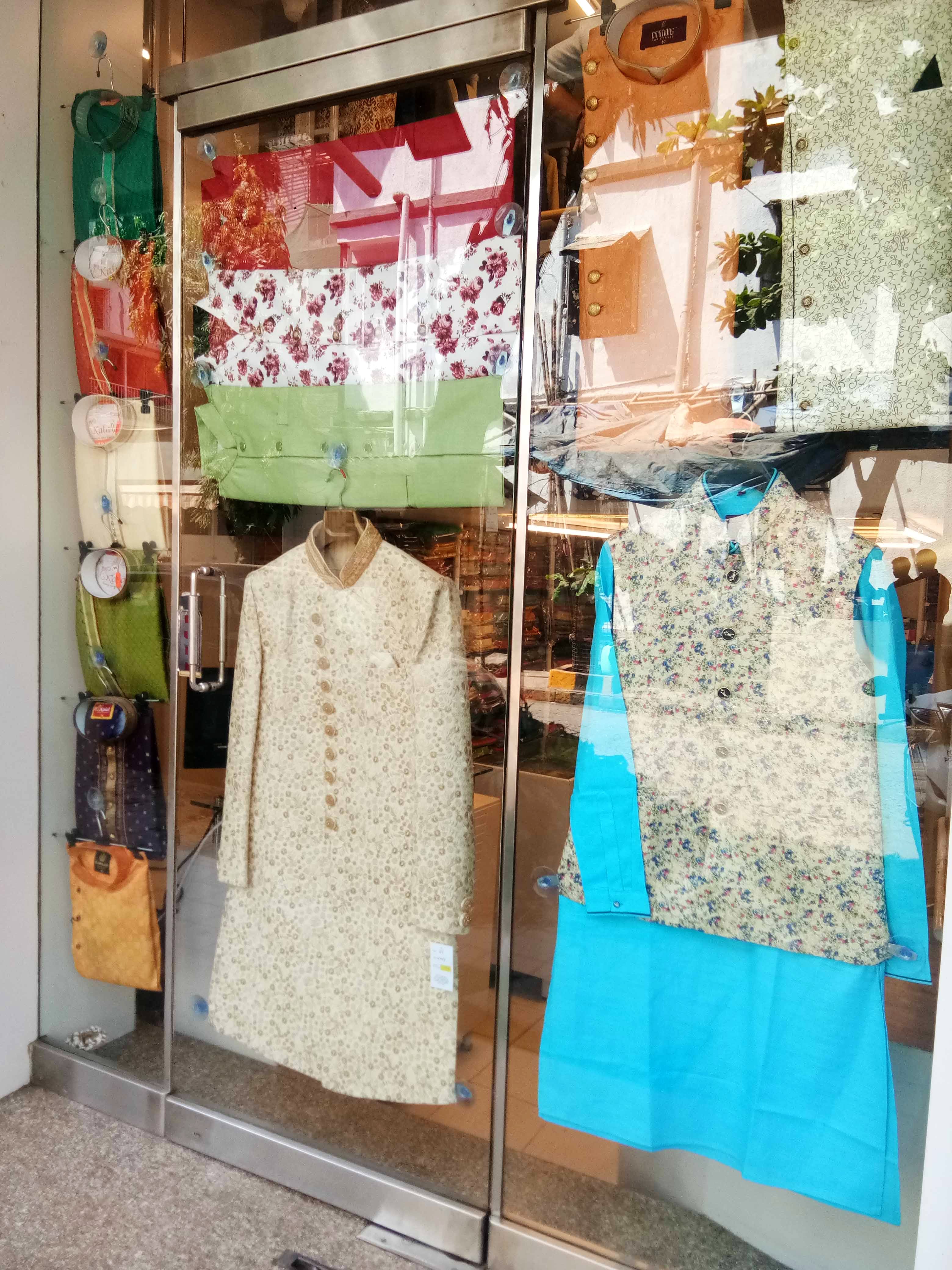 Green,Boutique,Fashion,Room,Clothes hanger,Display window,Textile,Door,T-shirt,Window