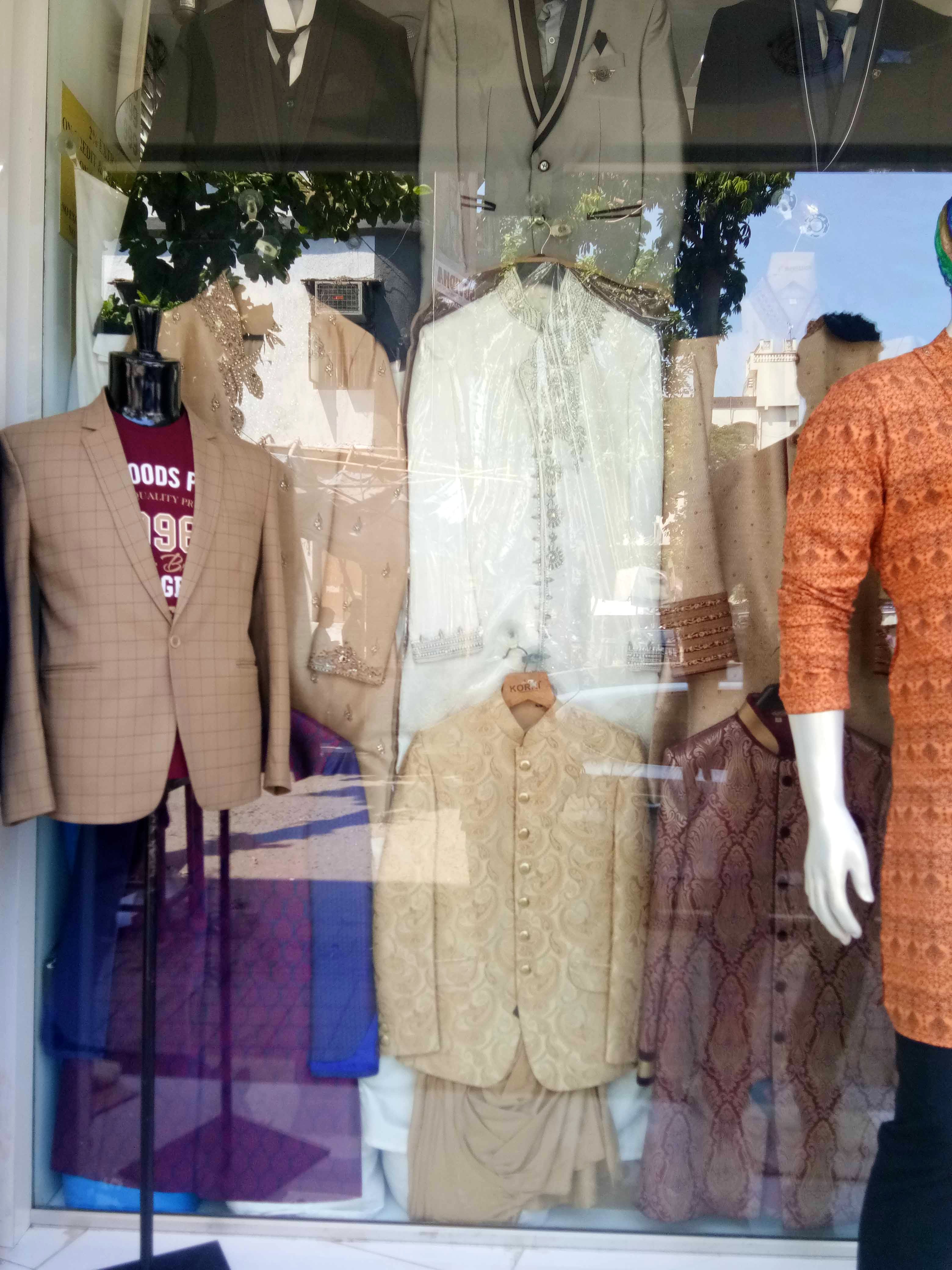 Clothing,Boutique,Display window,Mannequin,Fashion,Outerwear,Jacket,Dress,Suit,Window