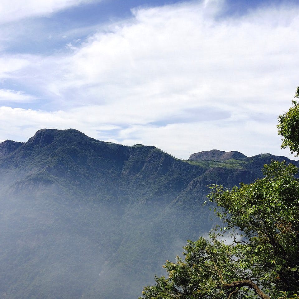 Sky,Mountainous landforms,Mountain,Hill station,Highland,Cloud,Vegetation,Atmospheric phenomenon,Natural landscape,Wilderness