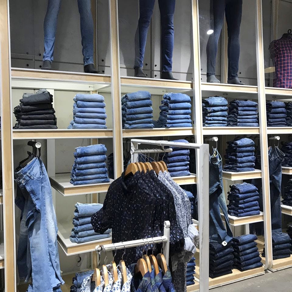 Clothes hanger,Denim,Jeans,Closet,Room,Footwear,Textile,Shoe,Window,Boutique